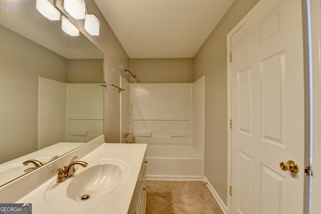 bathroom with tile patterned floors, baseboards, vanity, and shower / bathtub combination