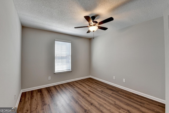 unfurnished room with baseboards, dark wood-style flooring, a textured ceiling, and a ceiling fan