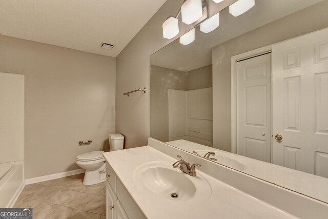 bathroom with toilet, tile patterned flooring, vanity, and walk in shower