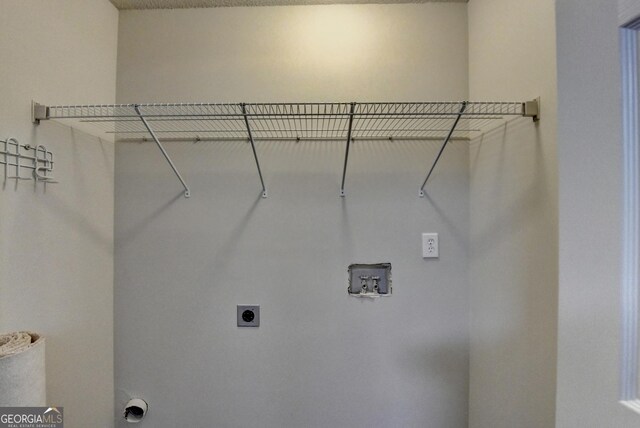 washroom with hookup for a washing machine, hookup for an electric dryer, and laundry area
