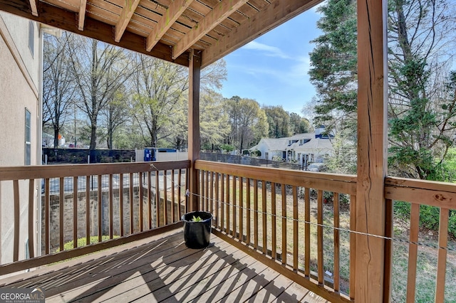 wooden terrace featuring fence