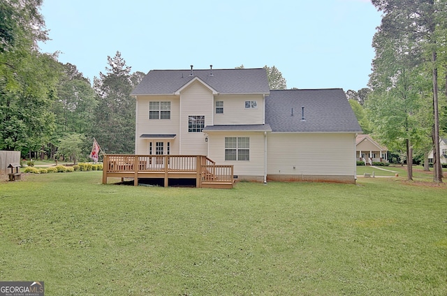 rear view of property featuring a yard and a deck