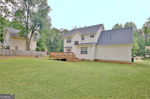 back of house featuring a lawn, fence, and a deck