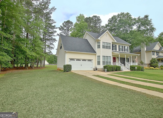 colonial home featuring a porch, an attached garage, driveway, and a front yard