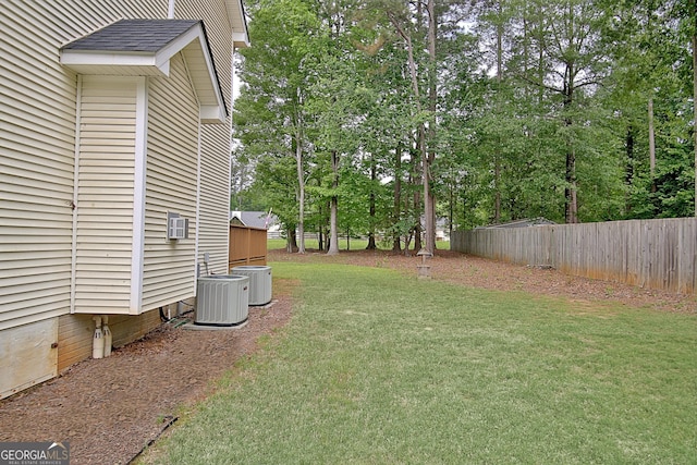 view of yard featuring fence and cooling unit