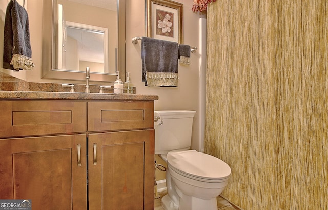 bathroom featuring vanity and toilet