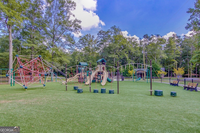 community playground with a lawn and fence