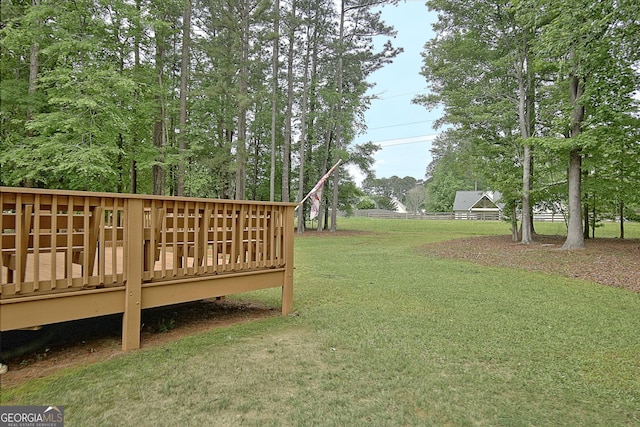 view of yard featuring fence and a deck