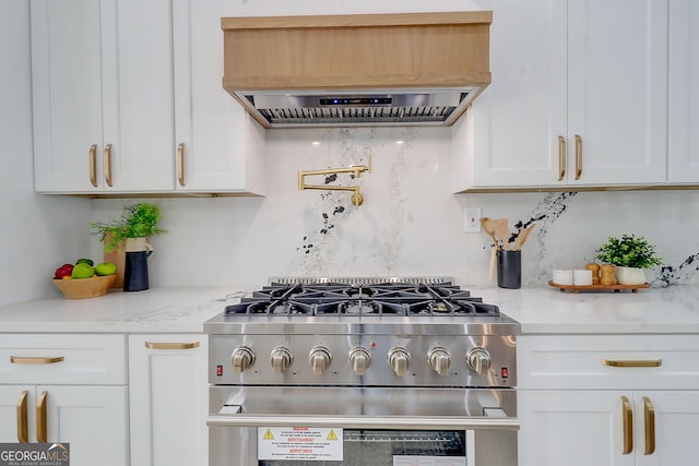 kitchen with white cabinetry, ventilation hood, high end stainless steel range oven, and custom exhaust hood