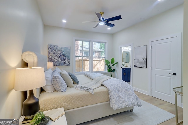 bedroom with light wood-style flooring, baseboards, ceiling fan, recessed lighting, and ensuite bath