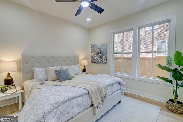 bedroom featuring baseboards, wood finished floors, recessed lighting, and a ceiling fan