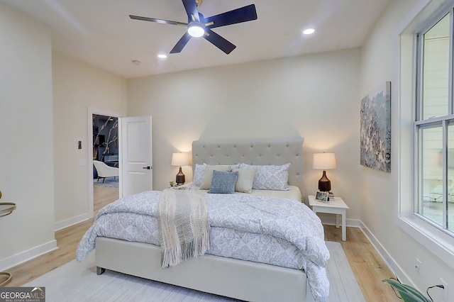 bedroom featuring light wood finished floors, baseboards, and recessed lighting