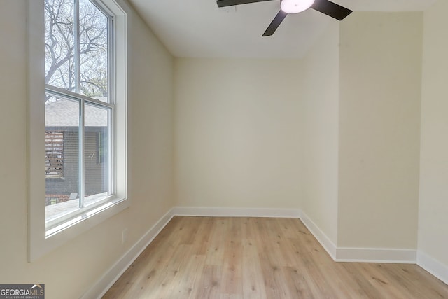unfurnished room featuring a ceiling fan, baseboards, and light wood-type flooring