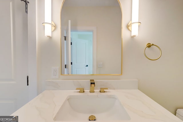bathroom with toilet and vanity