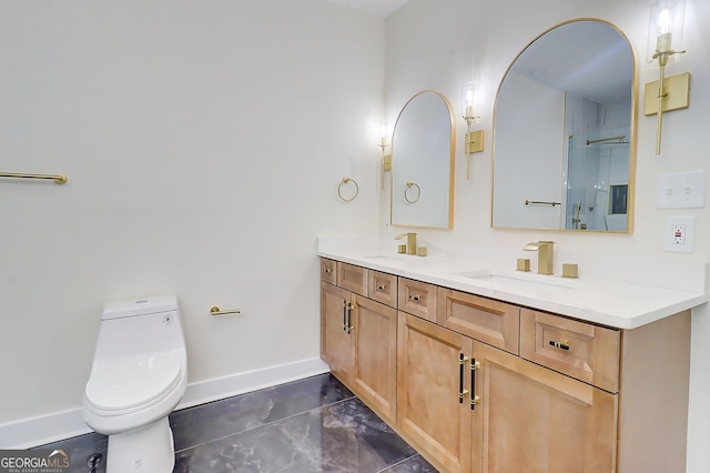 full bath featuring baseboards, double vanity, a sink, and toilet