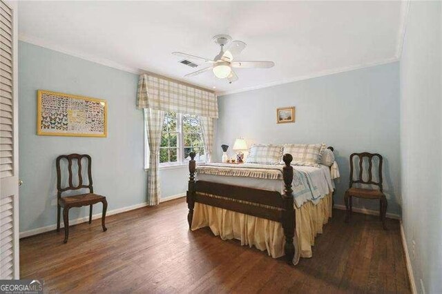 bedroom featuring dark wood-style floors, visible vents, and ornamental molding