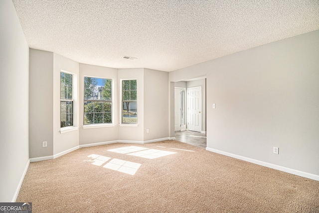 498 Pecan Wood Cir, Fairburn, GA 30213 - carpeted empty room with baseboards and a textured ceiling