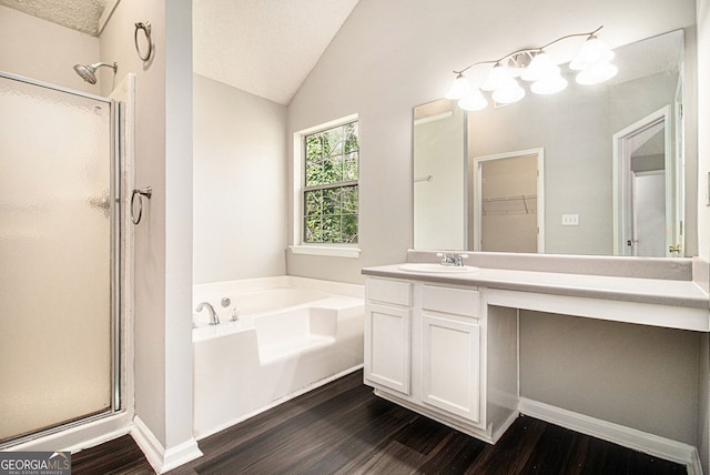 498 Pecan Wood Cir, Fairburn, GA 30213 - full bathroom featuring a stall shower, wood finished floors, a garden tub, vanity, and vaulted ceiling