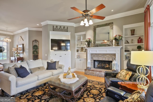 55 Hazelbrook Way, Acworth, GA 30101 - living area with crown molding, ceiling fan, built in features, a fireplace, and wood finished floors