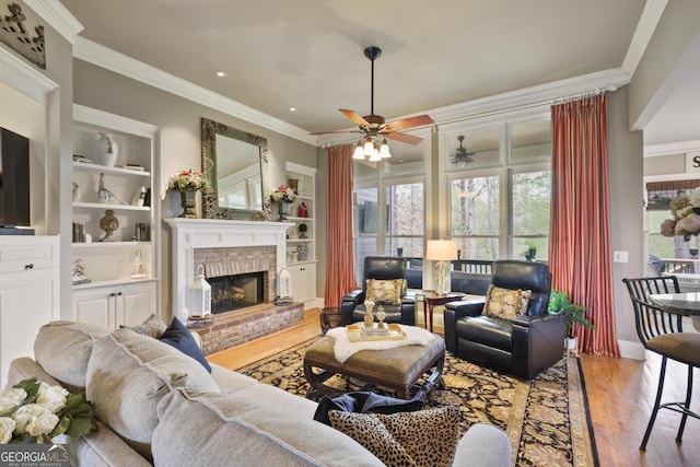 55 Hazelbrook Way, Acworth, GA 30101 - living area with crown molding, built in shelves, a fireplace, wood finished floors, and ceiling fan