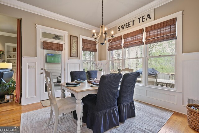 55 Hazelbrook Way, Acworth, GA 30101 - dining room featuring an inviting chandelier, crown molding, and light wood-style floors