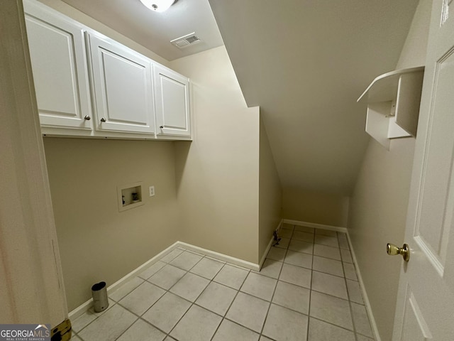 clothes washing area with visible vents, baseboards, light tile patterned floors, washer hookup, and cabinet space