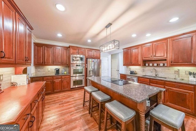 4408 Meadowwood Dr, Loganville, GA 30052 - kitchen with crown molding, a sink, a breakfast bar, appliances with stainless steel finishes, and decorative backsplash