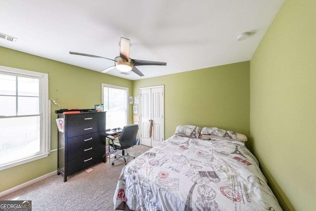 4408 Meadowwood Dr, Loganville, GA 30052 - bedroom with a closet, visible vents, baseboards, a ceiling fan, and light colored carpet