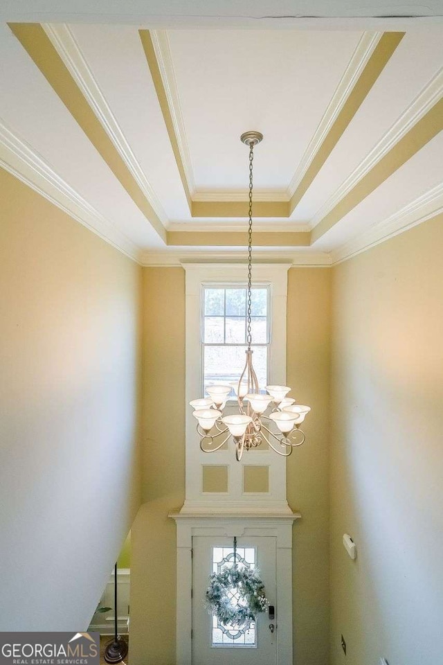 4408 Meadowwood Dr, Loganville, GA 30052 - details with an inviting chandelier, a raised ceiling, and ornamental molding