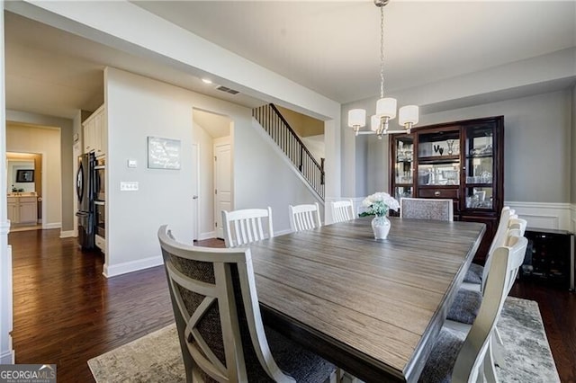 4870 Odum View Ln, Cumming, GA 30040 - dining area with a chandelier, stairway, and dark wood-style floors