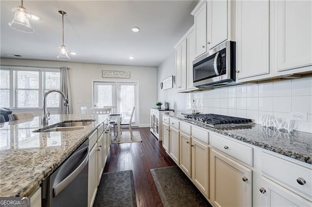 4870 Odum View Ln, Cumming, GA 30040 - kitchen featuring appliances with stainless steel finishes, dark wood-style flooring, decorative backsplash, recessed lighting, and light stone countertops