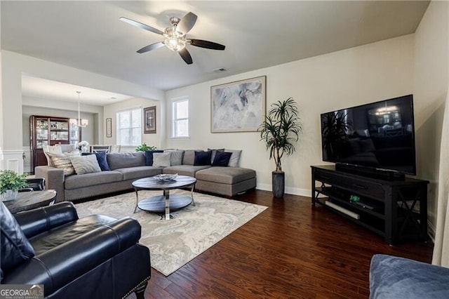4870 Odum View Ln, Cumming, GA 30040 - living room featuring a ceiling fan, dark wood-type flooring, and a chandelier