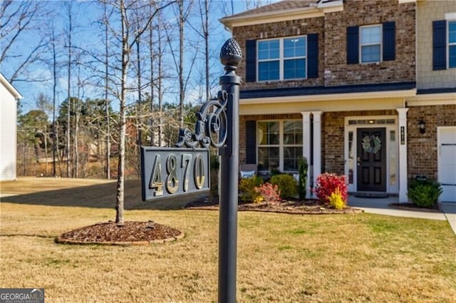 4870 Odum View Ln, Cumming, GA 30040 - view of front of house with a front lawn, brick siding, and a porch