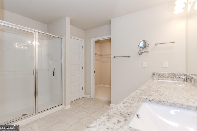 3627 Canyon Springs Dr, Oakwood, GA 30566 - bathroom with a sink, a walk in closet, a stall shower, and tile patterned floors