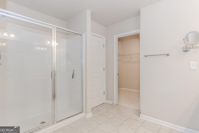 3627 Canyon Springs Dr, Oakwood, GA 30566 - bathroom with a walk in closet, baseboards, tile patterned flooring, and a shower stall