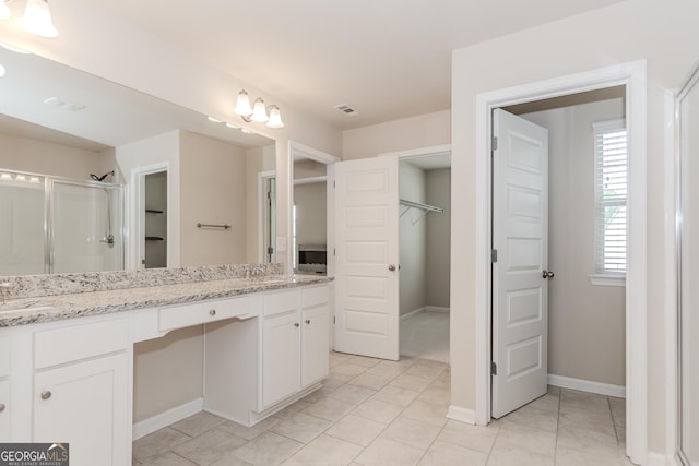3627 Canyon Springs Dr, Oakwood, GA 30566 - full bath with a sink, baseboards, a stall shower, a walk in closet, and double vanity
