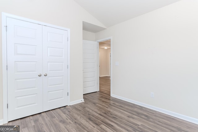3627 Canyon Springs Dr, Oakwood, GA 30566 - unfurnished bedroom with lofted ceiling, a closet, baseboards, and wood finished floors