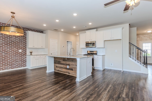 3627 Canyon Springs Dr, Oakwood, GA 30566 - kitchen with stainless steel appliances, dark wood-type flooring, recessed lighting, white cabinetry, and backsplash
