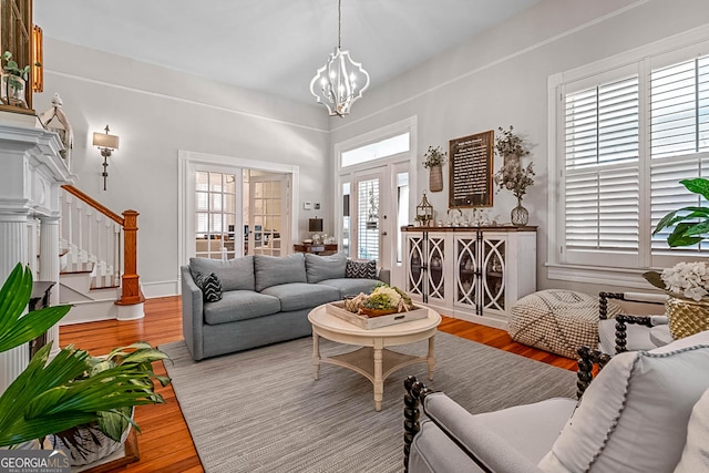 2173 Conyers St SE, Covington, GA 30014 - living area with stairs, wood finished floors, and a chandelier