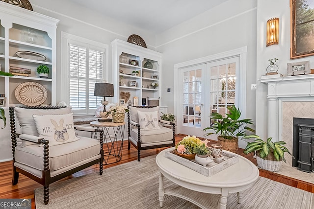 2173 Conyers St SE, Covington, GA 30014 - living area featuring a tiled fireplace, french doors, and wood finished floors