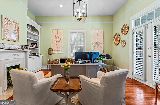 2173 Conyers St SE, Covington, GA 30014 - office area with a fireplace, a chandelier, and wood finished floors