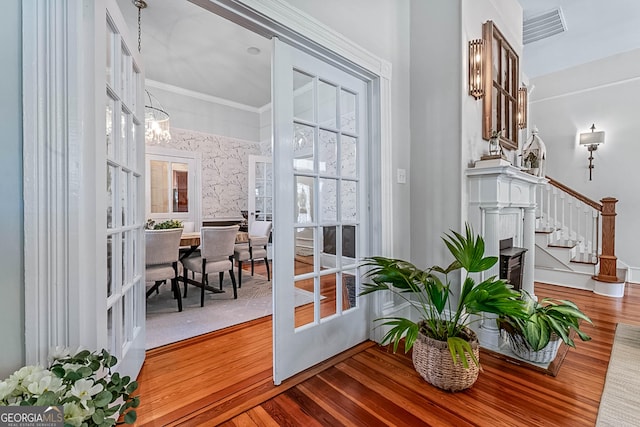 2173 Conyers St SE, Covington, GA 30014 - doorway to outside with stairway, wood finished floors, and a chandelier