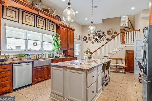 2173 Conyers St SE, Covington, GA 30014 - kitchen featuring appliances with stainless steel finishes, light tile patterned flooring, a center island, a sink, and recessed lighting