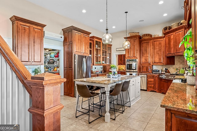 2173 Conyers St SE, Covington, GA 30014 - kitchen featuring stainless steel appliances, decorative backsplash, a breakfast bar, recessed lighting, and light stone countertops