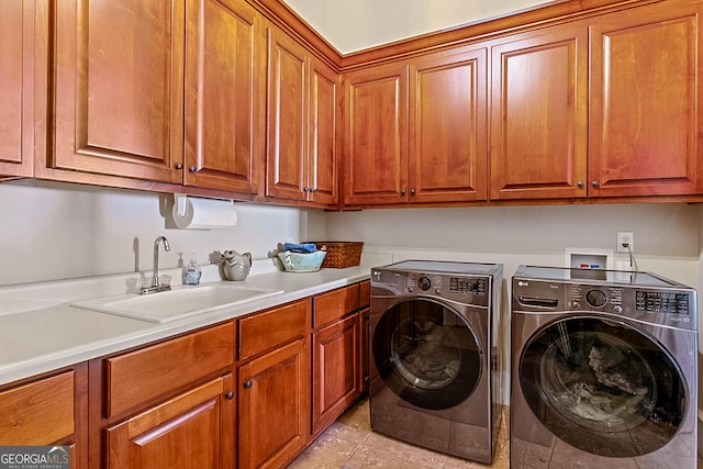2173 Conyers St SE, Covington, GA 30014 - laundry room featuring cabinet space, washer and clothes dryer, and light tile patterned floors