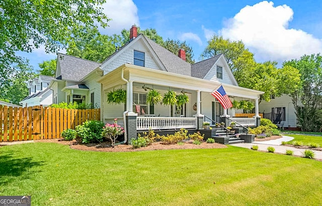 2173 Conyers St SE, Covington, GA 30014 - view of front of property featuring covered porch, a chimney, roof with shingles, and a ceiling fan