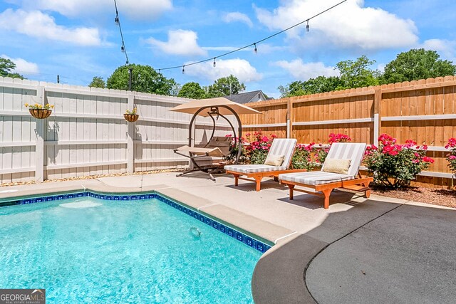 2173 Conyers St SE, Covington, GA 30014 - view of pool featuring a fenced backyard and a patio area