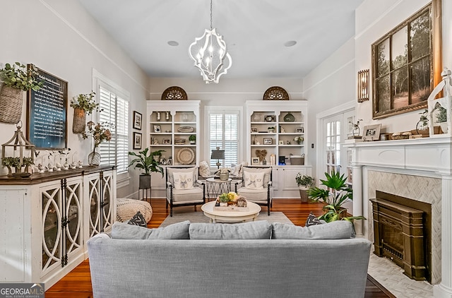 2173 Conyers St SE, Covington, GA 30014 - living area with plenty of natural light, a chandelier, a fireplace, and wood finished floors