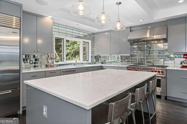 4 W Wesley Rdg NW, Atlanta, GA 30327 - kitchen featuring gray cabinetry, high quality appliances, decorative backsplash, a kitchen island, and a tray ceiling