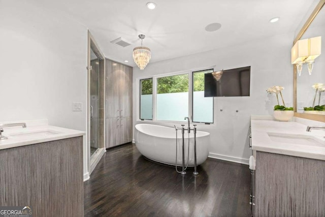 4 W Wesley Rdg NW, Atlanta, GA 30327 - full bathroom with two vanities, wood finished floors, a soaking tub, a shower stall, and recessed lighting